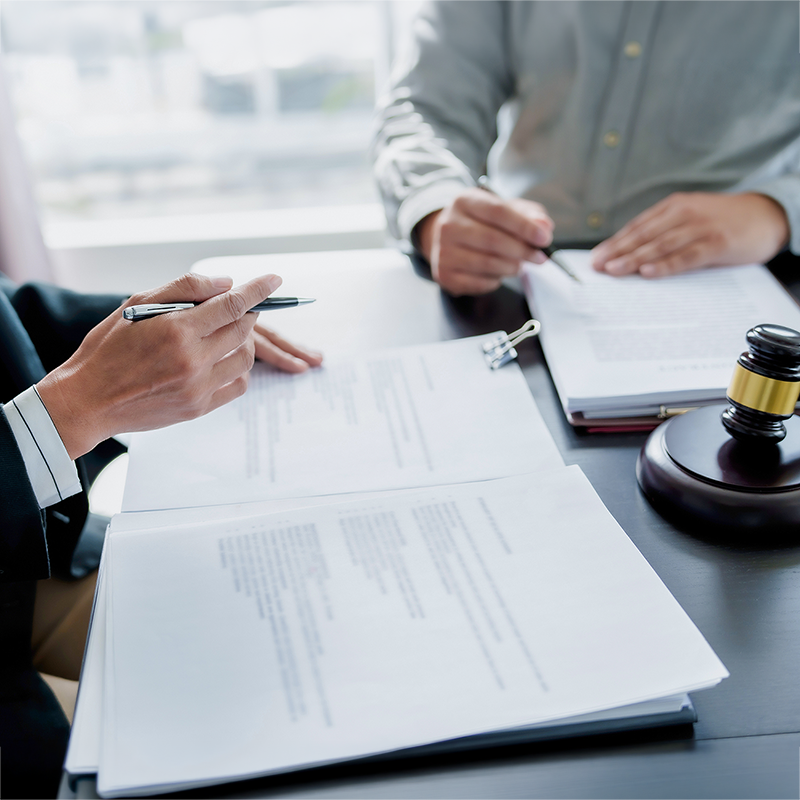 attorney consultation Attorney reviewing legal documents during a client consultation