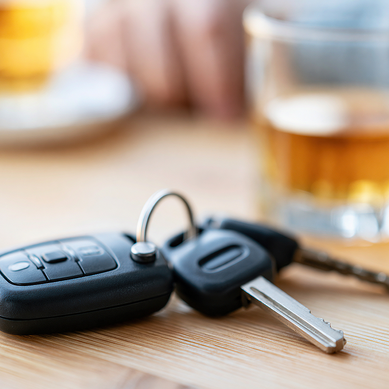 Car keys beside an alcoholic drink